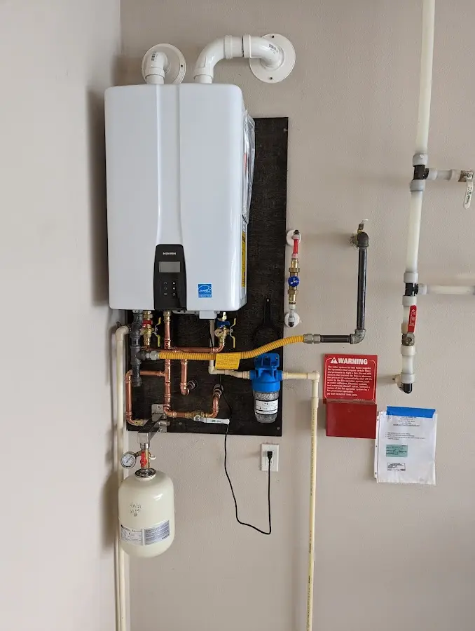 Professional plumber installing copper piping in a Newberry home